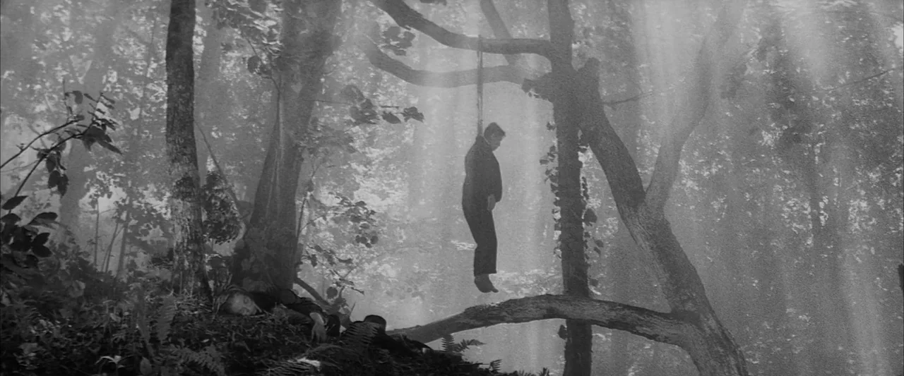 The Human Condition III: A Soldier’s Prayer (1961) movie still: wide — A misty, dense woodland area with heavy foliage and large, gnarled tree…