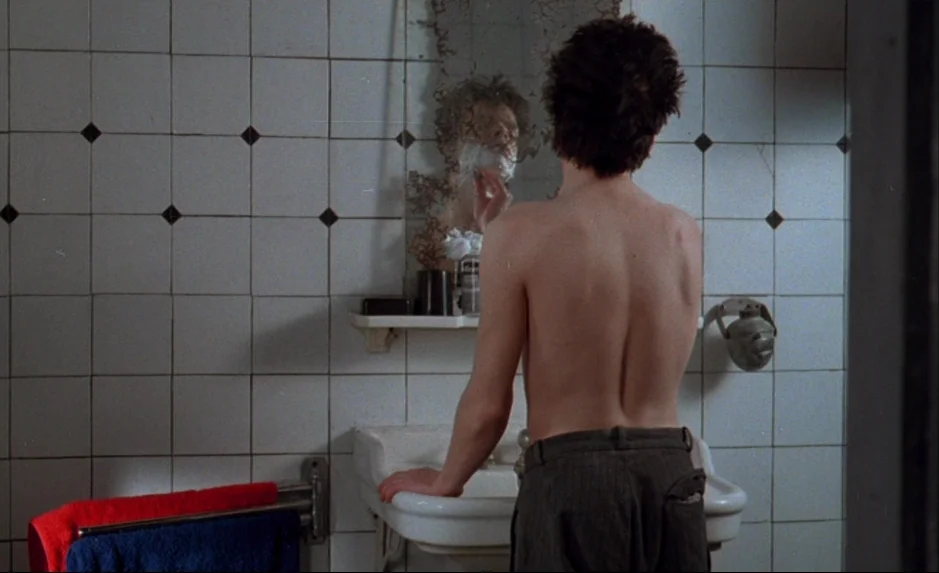Mauvais Sang (Bad Blood) (The Night Is Young) (1986) movie still: medium — A tiled bathroom features walls decorated with small black…