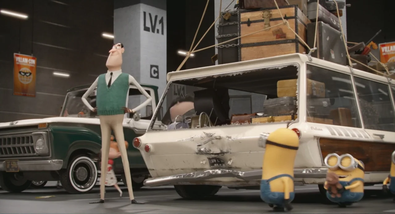 Minions (2015) movie still: medium — A spacious concrete parking garage structure serves as the backdrop for a packed vehicle. A slender animated…