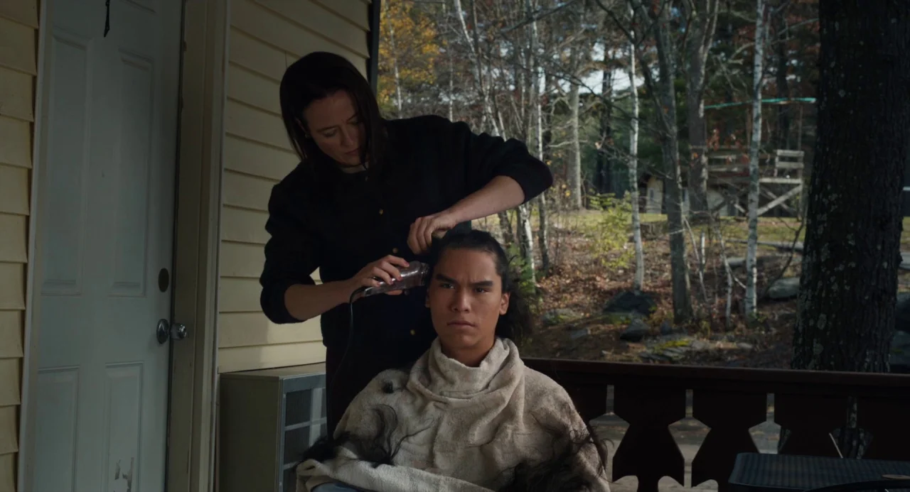 The Miseducation of Cameron Post (2018) movie still: medium — A residential outdoor porch features yellow siding and a wooden railing near bare…