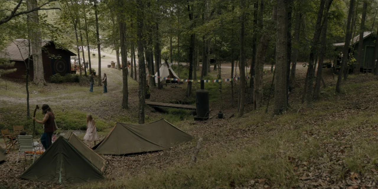 Mark Felt: The Man Who Brought Down the White House (2017) movie still: wide — A clearing in a dense forest features multiple canvas tents and…
