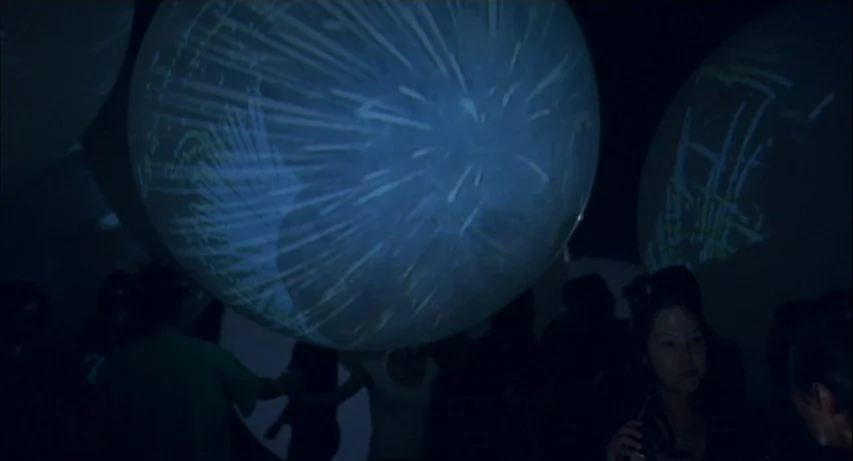 Lost In Translation (2003) movie still: medium — A dimly lit room contains large, spherical objects with light projections on their surfaces.…