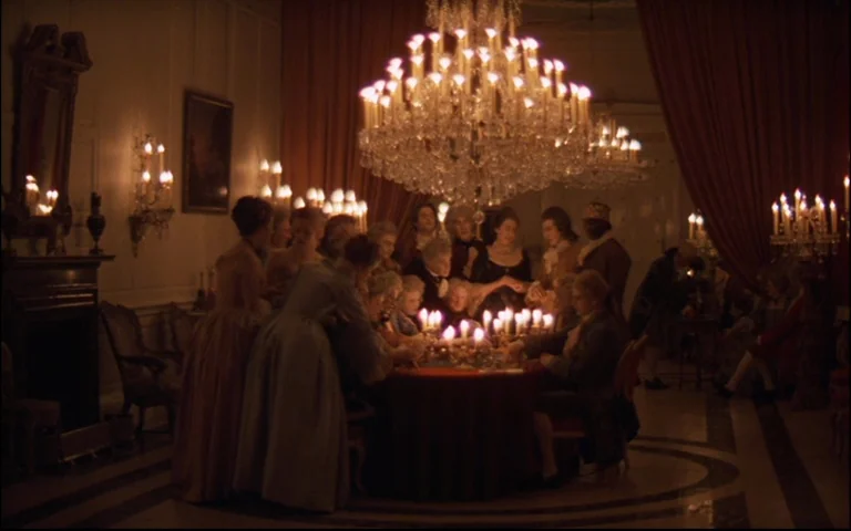 Barry Lyndon (1975) movie still: wide — A dimly lit ballroom features a large group gathered around a central table. People in formal period attire…