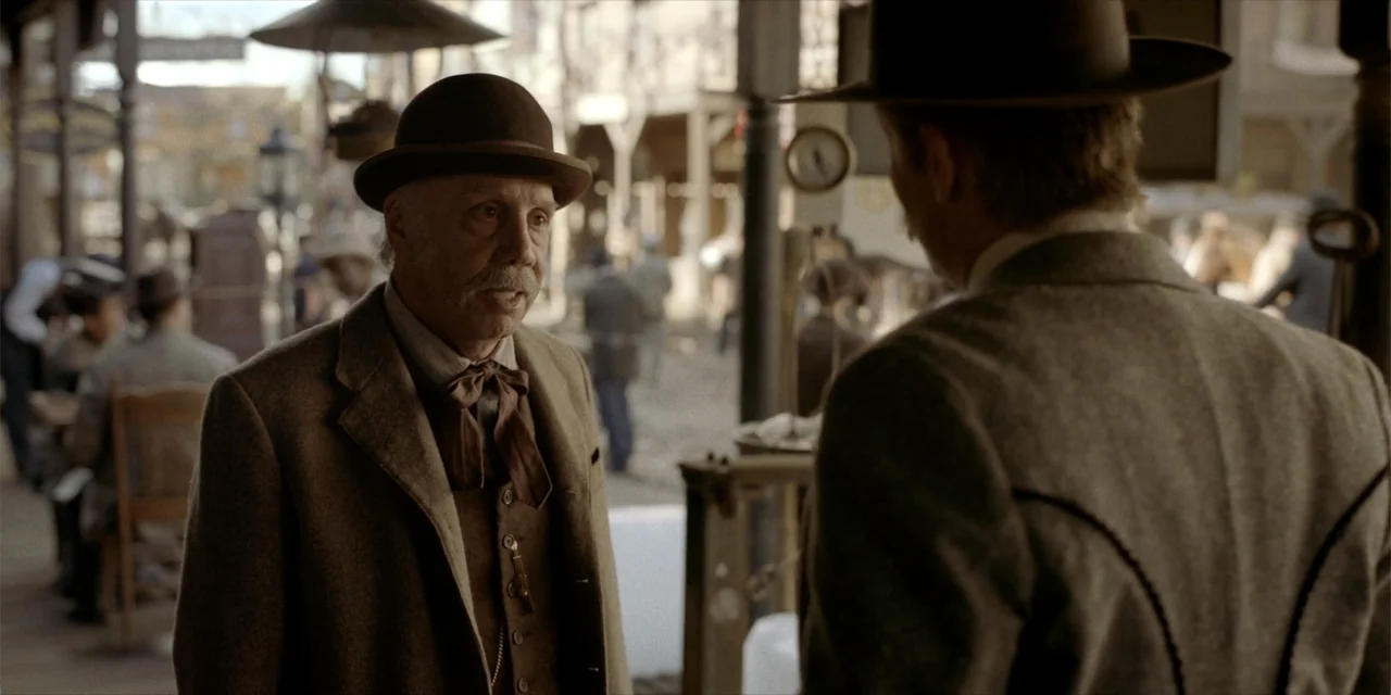 Deadwood: The Movie (2019) movie still: medium — A dusty outdoor town square features wooden structures and period-accurate architecture in the…