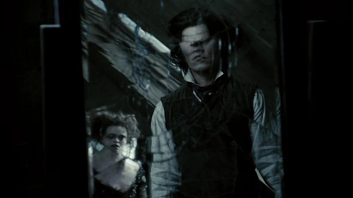 Sweeney Todd: The Demon Barber of Fleet Street (2007) movie still: medium — A dark, wood-paneled room is visible through the reflection of a large…