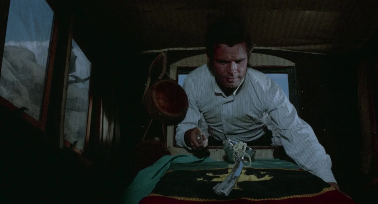 The Hellbenders (1967) movie still: medium — The interior of a cramped wooden stagecoach features leather-toned accessories and exterior light…