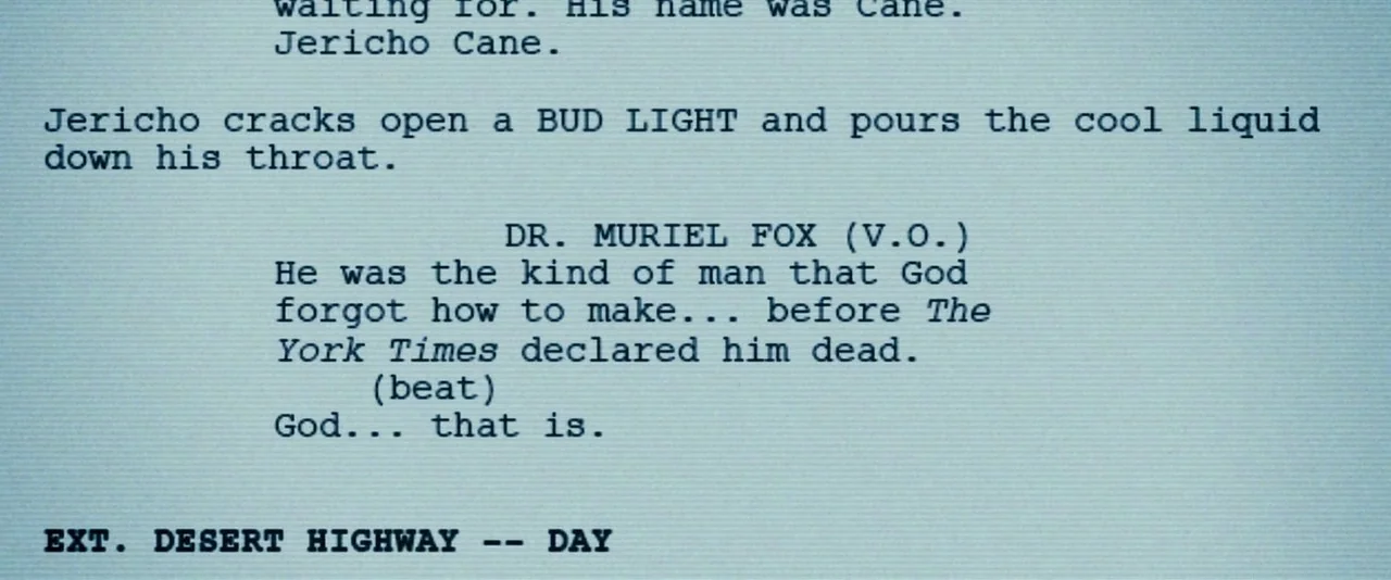 Southland Tales (2006) movie still: closeup — A light blue digital screen shows black typewriter-style text from a movie script. The text outlines…