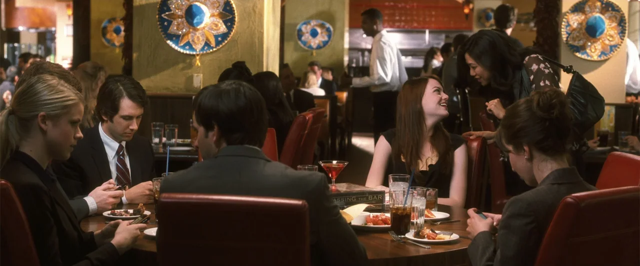 Crazy, Stupid, Love. (2011) movie still: medium — A dimly lit restaurant interior features multiple booths with dark wood paneling and red…