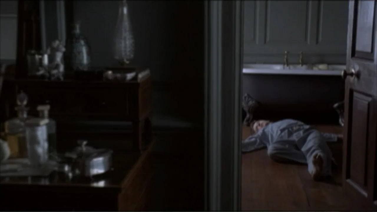 The Gathering Storm (2002) movie still: medium — A dimly lit room overlooks a bathroom where a child rests on the floor. A boy wearing grey pajamas…