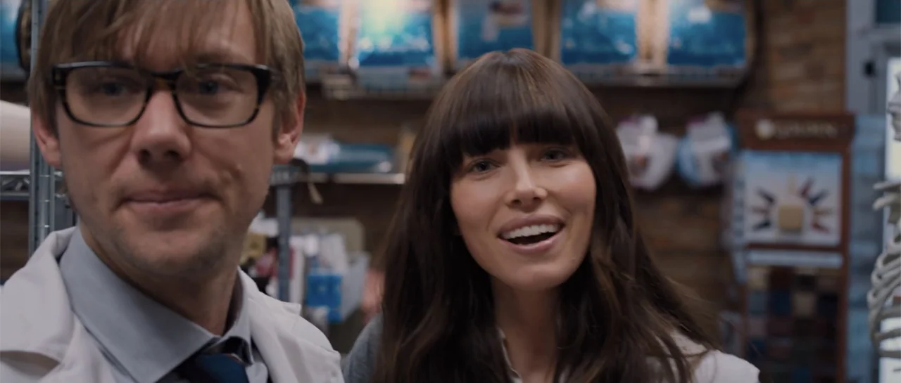 The Truth About Emanuel (2013) movie still: medium — An interior shot of a pharmacy with retail shelves and product displays in focus. A man and a…