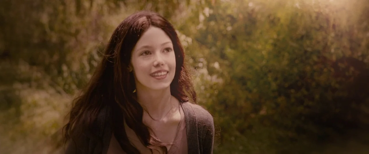 The Twilight Saga: Breaking Dawn – Part 1 (2011) movie still: closeup — A sunlit wooded area features dense foliage and dappled light in the…