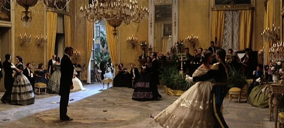 The Leopard (1963) movie still: wide — An opulent 19th-century ballroom features gilded walls, yellow drapes, and large crystal chandeliers. Guests…