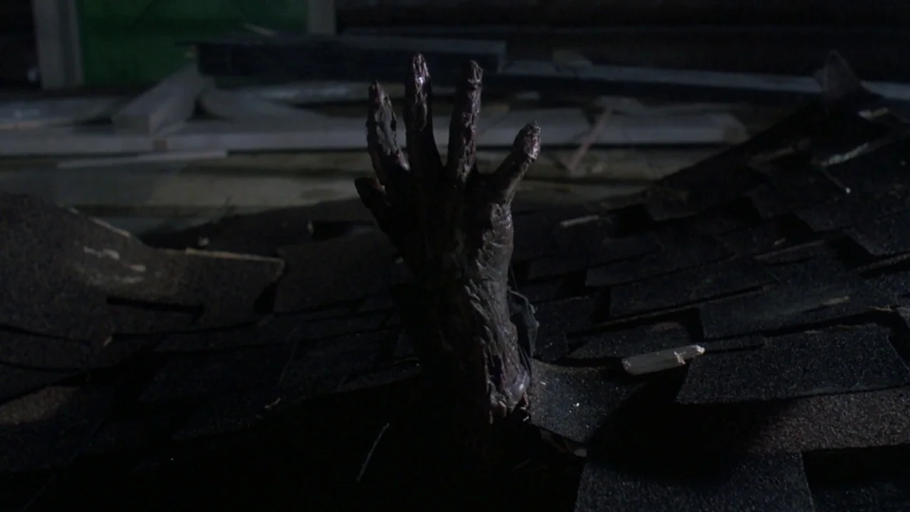 Friday the 13th Part VII: The New Blood (1988) movie still: closeup — A dark, textured surface of shingles is shown under dim, low-key lighting. A…