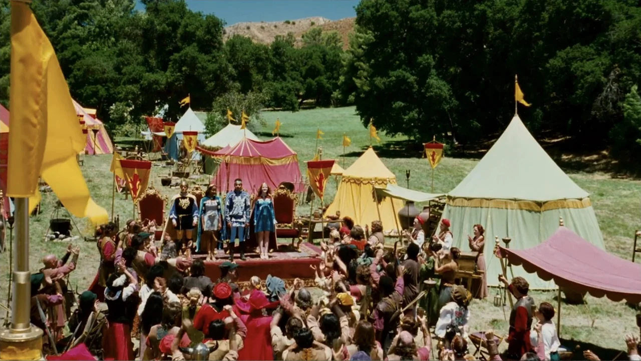 Epic Movie (2007) movie still: wide — A field filled with brightly colored medieval tents and a raised wooden platform. A large crowd cheers for…
