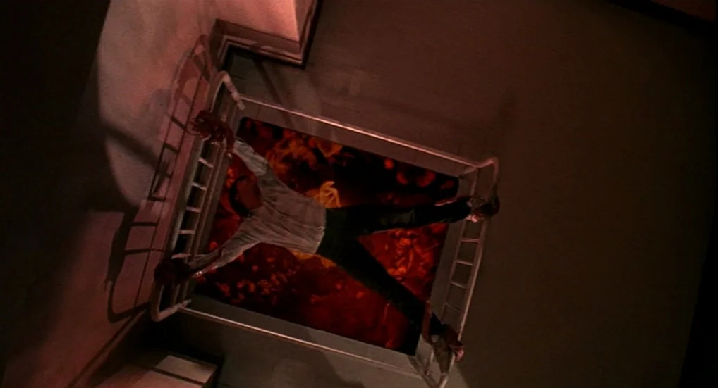 A Nightmare On Elm Street 3: Dream Warriors (1987) movie still: fullbody — A dark industrial metallic structure with an open shaft containing fiery,…
