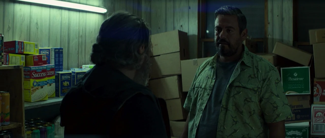 You Were Never Really Here (2017) movie still: medium — A cluttered storage area filled with cardboard boxes and shelves stocked with rice boxes. A…