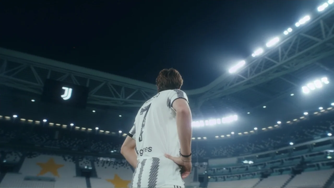 Federico Chiesa - Back on Track (2023) movie still: medium — A professional sports arena at night with bright floodlights glowing above the stands.…