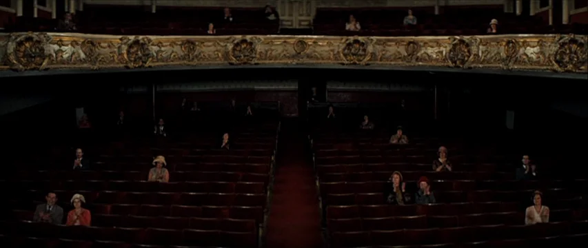 The Boy Friend (1971) movie still: wide — An ornate historic theater with red velvet seating and decorative gold balcony railings. Audience members…