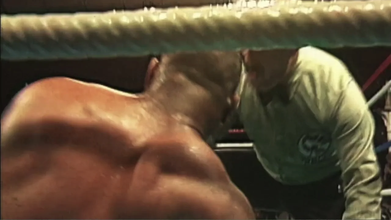 Mike Tyson: Undisputed Truth (2013) movie still: medium — A close-up view inside a boxing ring, bounded by thick white rope. A shirtless, sweaty…