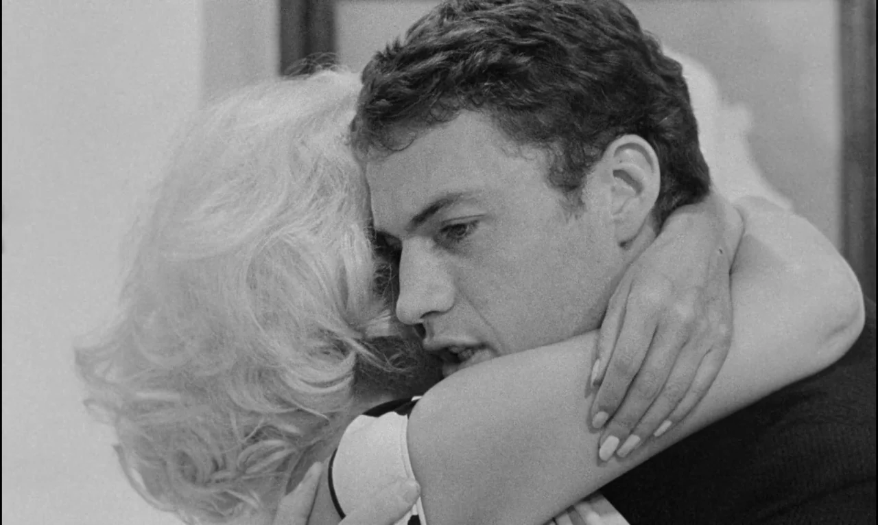 Bay of Angels (1963) movie still: closeup — A man and a woman are in an interior setting. They are in a close embrace.