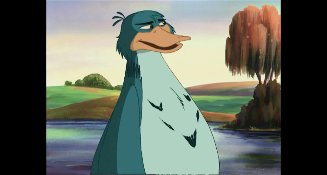 The Sissy Duckling (1999) movie still: medium — A cartoon waterfowl stands in front of a calm lake and grassy banks. The anthropomorphic blue duck…