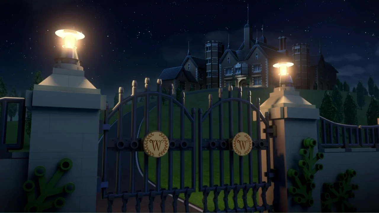 LEGO DC Batman: Family Matters (2019) movie still: establishing — A nighttime view of a large mansion entrance with an iron gate and two pillars.…