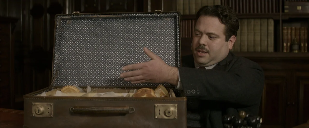 Fantastic Beasts and Where to Find Them (2016) movie still: medium — A dark wooden room lined with bookshelves serves as a study or private library.…
