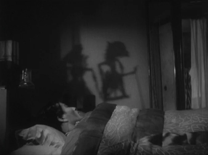 Drunken Angel (1948) movie still: medium — A dimly lit room features a man lying under patterned bedsheets in the foreground. Sharp shadows of two…