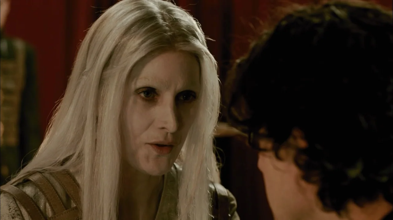 Silent Hill: Revelation 3D (2012) movie still: closeup — An interior space features a dark red wall in the background. A woman with long white hair…