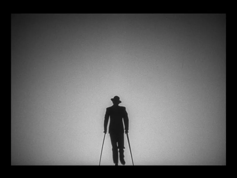 Double Indemnity (1944) movie still: fullbody — A featureless, light-grey background surrounds a figure in the middle of the frame. The figure walks…