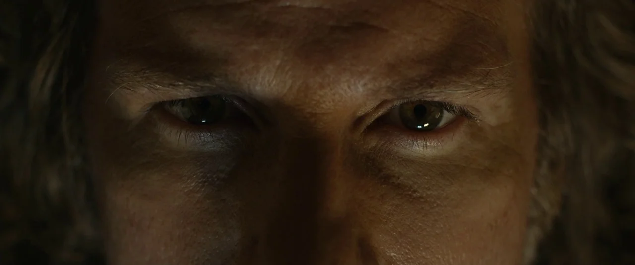 Before I Wake (2016) movie still: closeup — A close-up view focuses entirely on the upper face of an adult man. The man stares directly into the…
