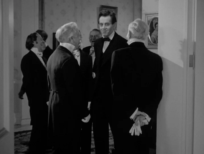 Young Mr. Lincoln (1939) movie still: medium — A well-appointed drawing room features patterned wallpaper and framed artwork on the walls. A small…