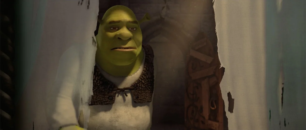 Shrek Forever After (2010) movie still: medium — A dark stone room with a wooden door is visible behind a torn white curtain. A green ogre in a…