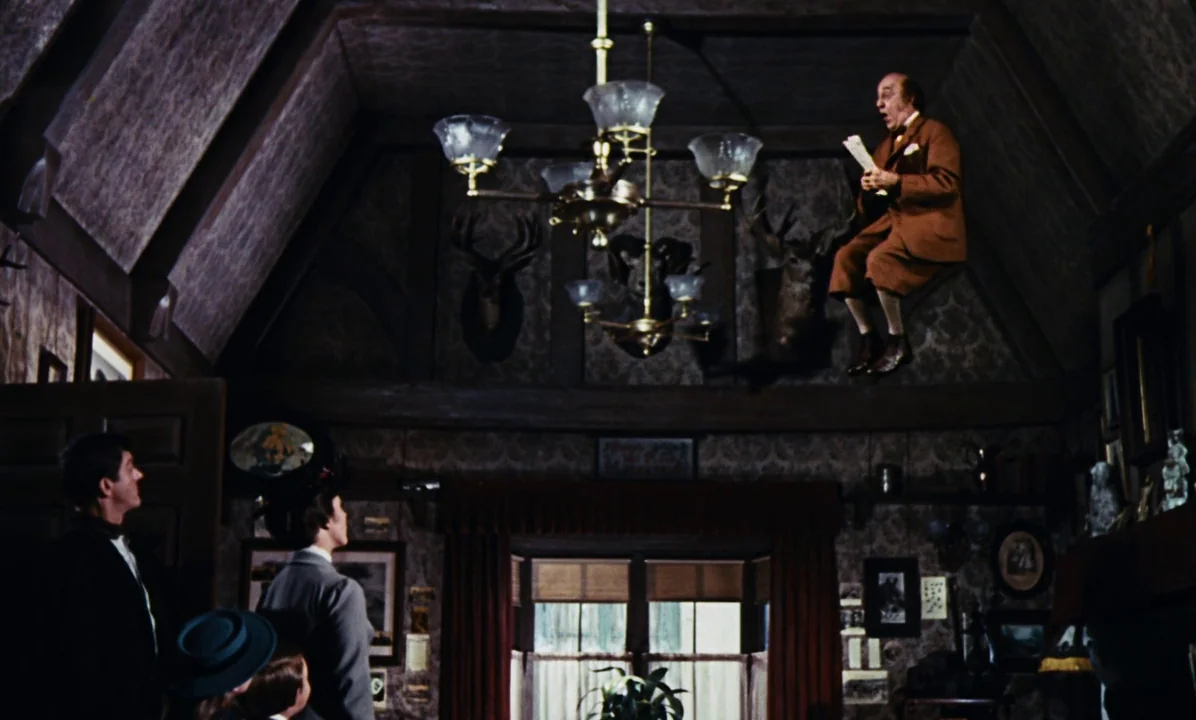 Mary Poppins (1964) movie still: wide — A vintage wood-paneled room features patterned wallpaper and multiple mounted deer taxidermy trophies. An…