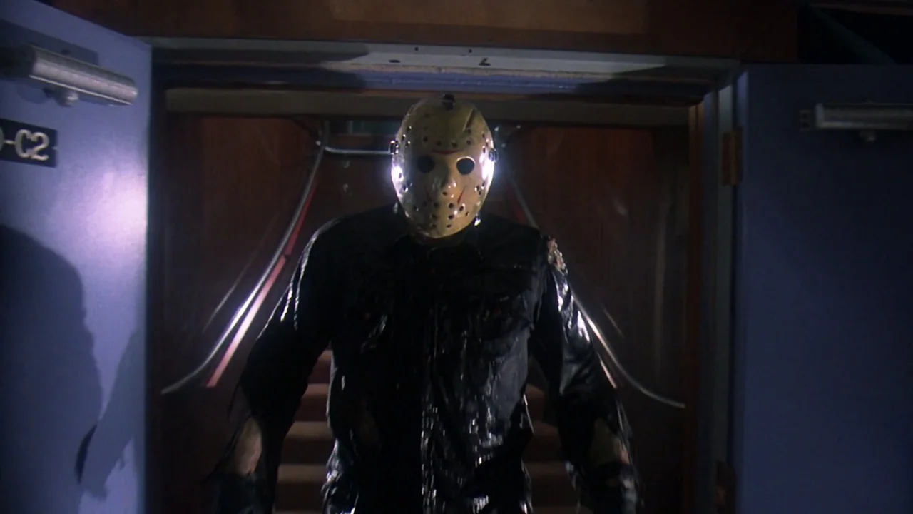 Friday the 13th Part VIII: Jason Takes Manhattan (1989) movie still: medium — A dark corridor features blue double doors with a visible 'C2' signage…