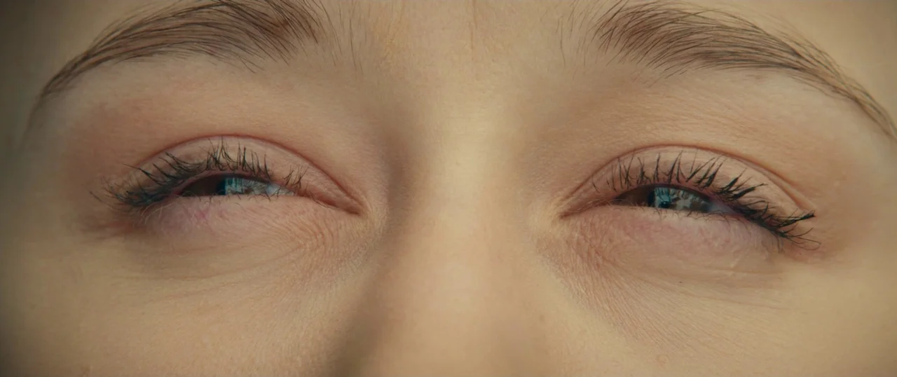 Final Girls (2015) movie still: closeup — An extreme close-up focuses on the upper face of a human subject. The eyes are partially closed in a…