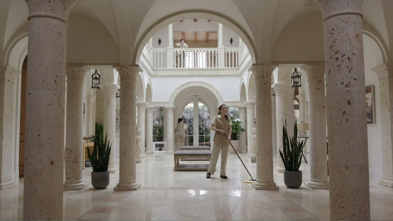 Get Hard (2015) movie still: fullbody — A spacious mansion atrium features stone columns, marble flooring, and a second-floor balcony railing. One…