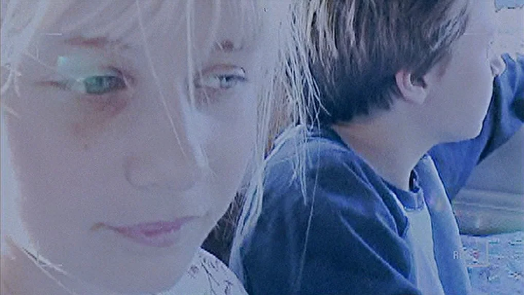 Mean Creek (2004) movie still: closeup — A close view inside a vehicle with two children sitting side by side. The girl appears in the foreground…