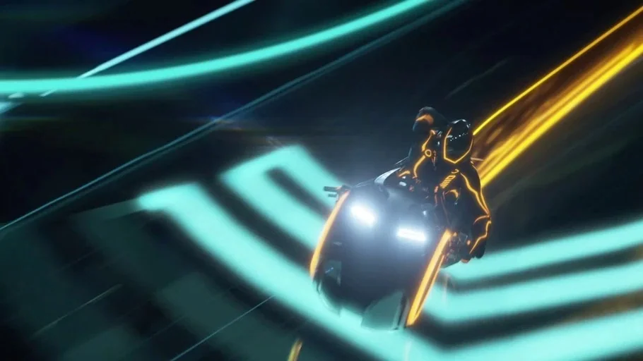 TRON: Legacy (2010) movie still: medium — A high-speed light cycle travels along a futuristic track marked by glowing neon patterns. The rider is…
