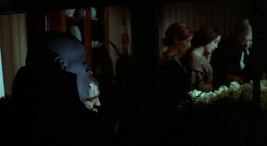 Nosferatu the Vampyre (Nosferatu Phantom Der Nacht) (1979) movie still: medium — A dimly lit room contains several people standing in a row by white…