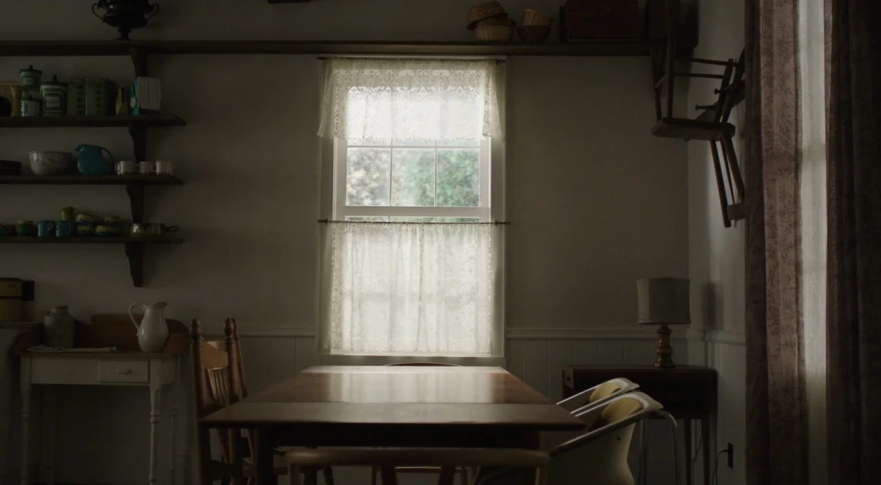 I Am The Pretty Thing That Lives In The House (2016) movie still: wide — An empty dining room features a wooden table centered before a window with…