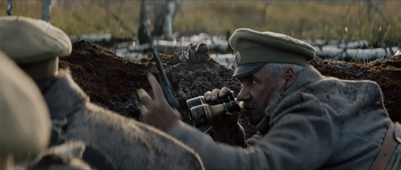 The Rifleman (2019) movie still: medium — A dug-out mud trench during a wartime conflict with scattered wooden debris nearby. An older soldier in…