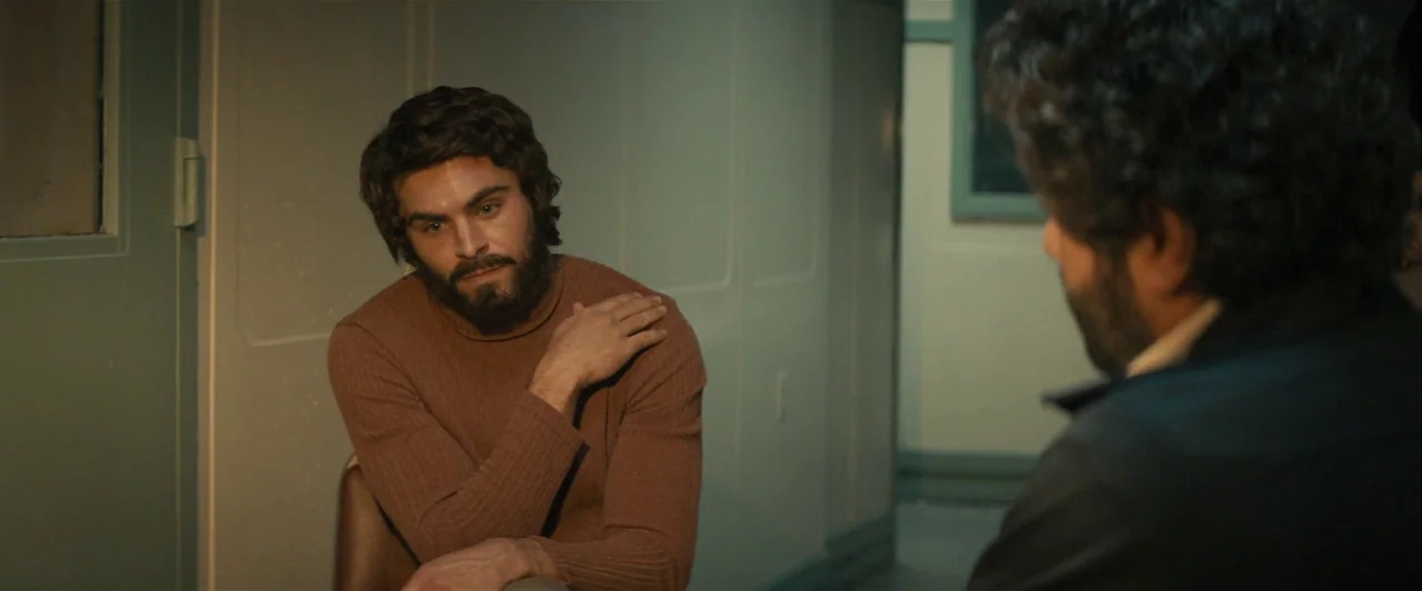 Extremely Wicked, Shockingly Evil and Vile (2019) movie still: medium — A dimly lit room with plain walls and a sterile appearance. One man with a…