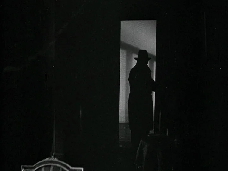 Mata Hari (1931) movie still: fullbody — A dark apartment interior features a person silhouetted against a bright window. The subject stands in the…
