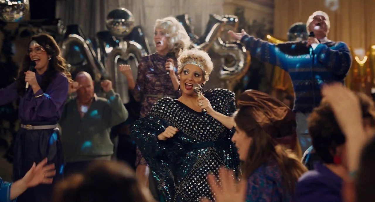 The Eyes of Tammy Faye (2021) movie still: medium — A festive party space decorated with silver foil balloons and spinning disco balls. Multiple…