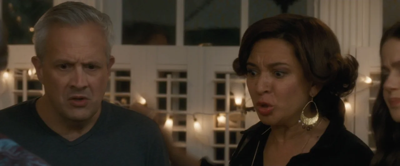 Life of the Party (2018) movie still: medium — A residential interior features a white window frame decorated with illuminated light bulbs. A man…