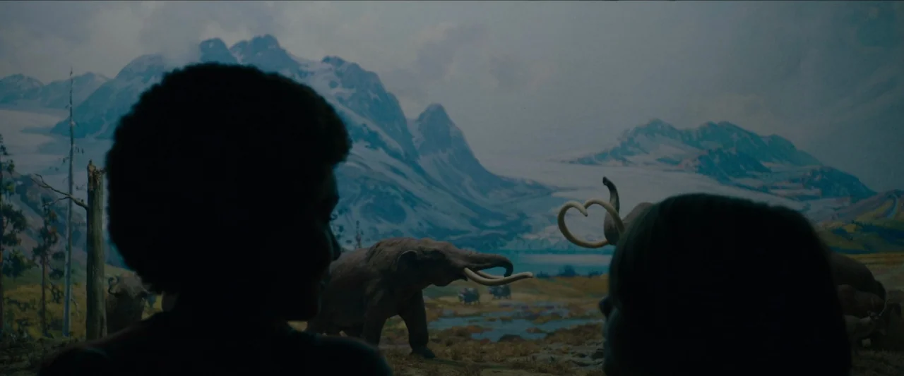 Wonderstruck (2017) movie still: medium — Two people watch a prehistoric diorama with painted mountain backgrounds and taxidermied mammoths. The…
