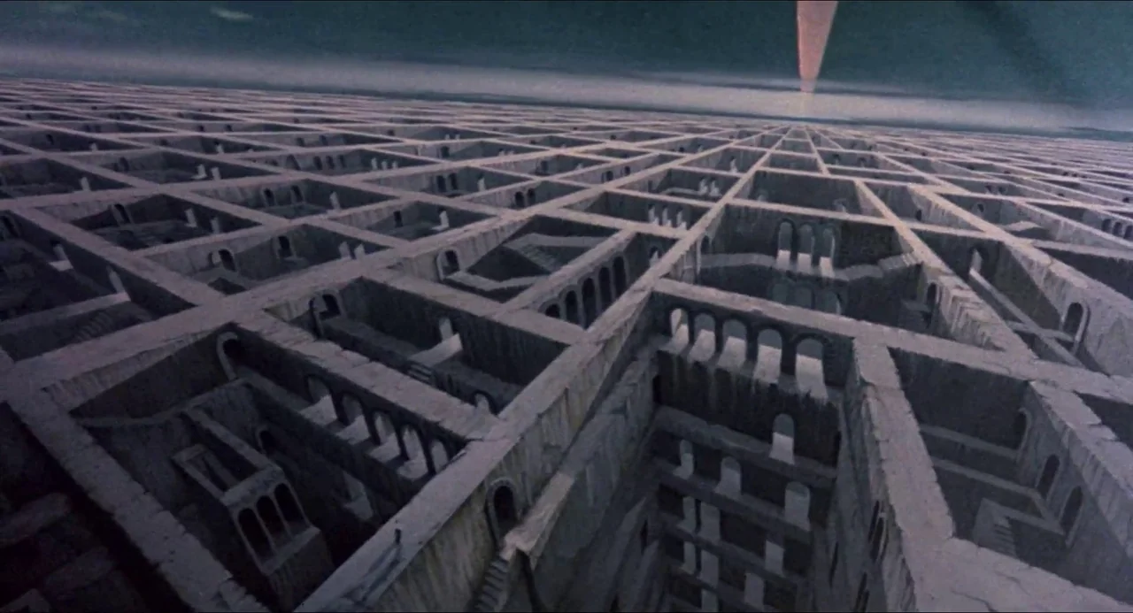 Hellbound: Hellraiser II (1988) movie still: establishing — A vast, repeating stone labyrinth extends toward a distant light in the dark sky. Narrow…