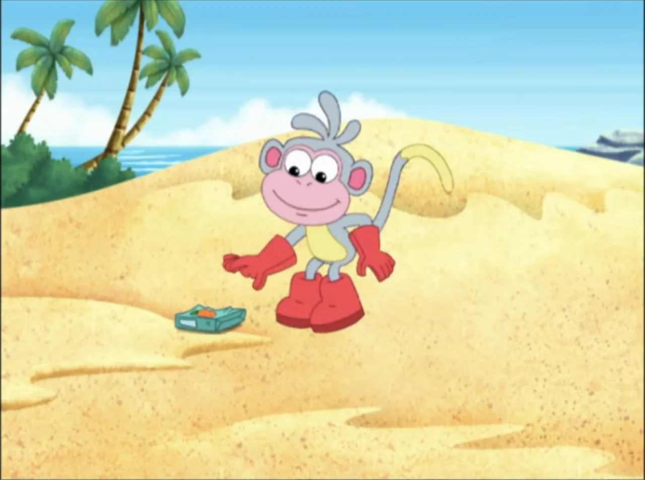 Dora the Explorer: Mermaid Adventures (2025) movie still: medium — A cartoon monkey stands on a yellow sandy beach with palm trees in view. The…