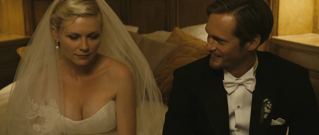 Melancholia (2011) movie still: medium — A dimly lit room with brown wall panels and large pillows on a bed. A bride and a groom in formal attire…